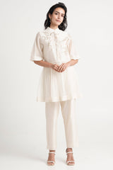 Ivory Abe 2.5 Tonal Embroidery Peplum Tunic Set by Madder Much, short sleeve peplum tunic and slim pants, front view