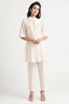 Ivory Abe 2.5 Tonal Embroidery Peplum Tunic Set by Madder Much, short sleeve peplum tunic and slim pants, front view