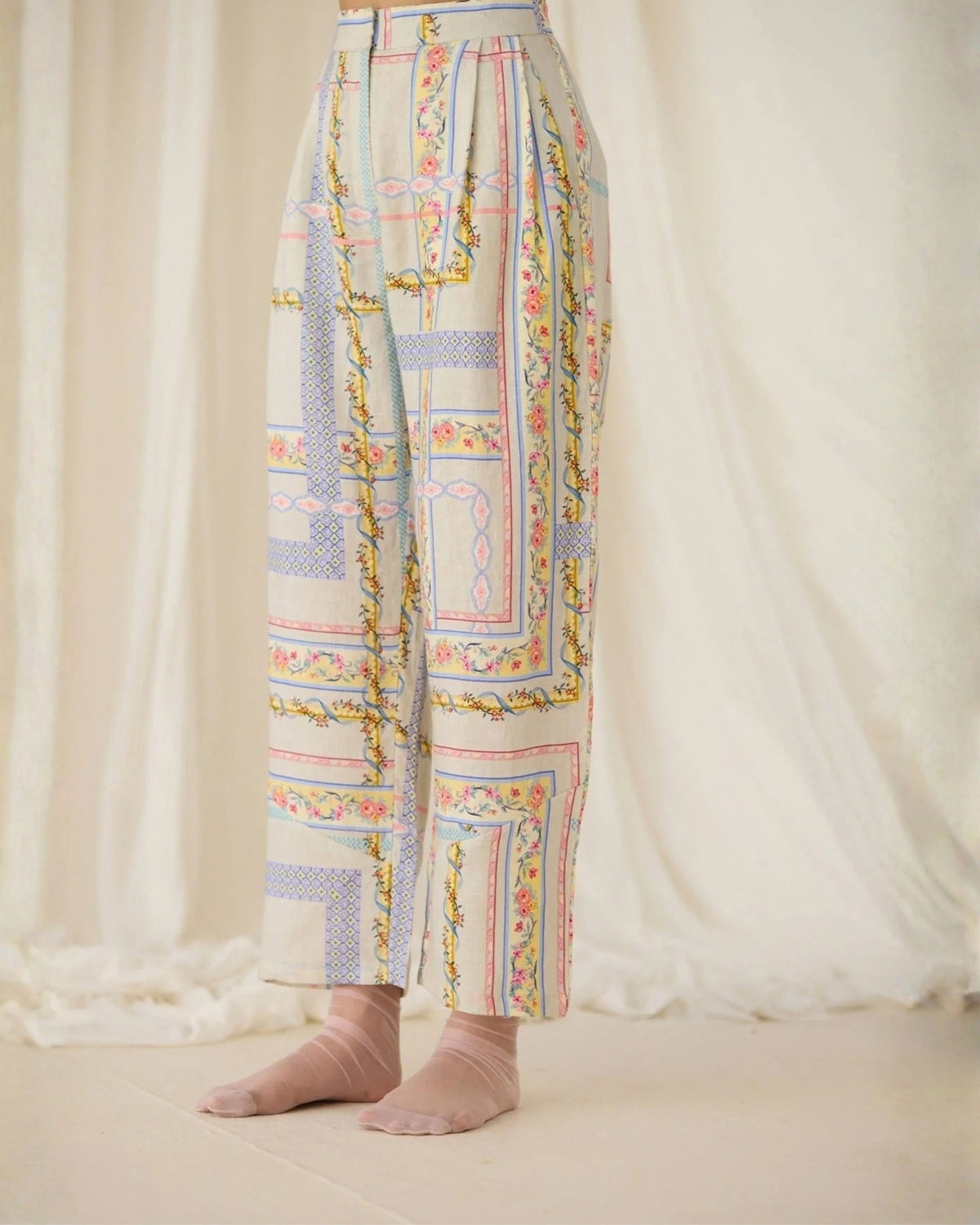 Close-up of the Ash Printed Pants lower legs showing the floral border print