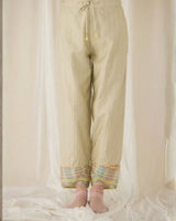 Pale sage Ash Tulip Pants with elastic back waist and checked cuffs, back view