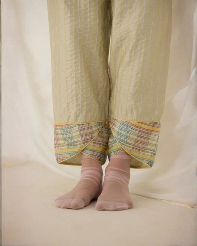 Close-up of the Ash Tulip Pants overlapping tulip hem with pastel check trim