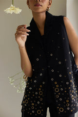 Close-up of the Black Denim Jacket lapel and scattered gold eyelet rings