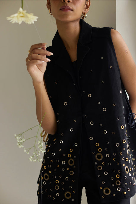 Close-up of the Black Denim Jacket lapel and scattered gold eyelet rings