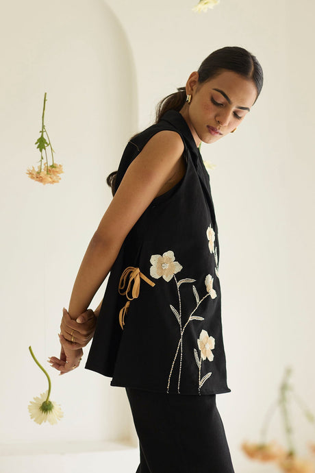 Black Denim Floral Jacket with tan side ties and black pants, side view
