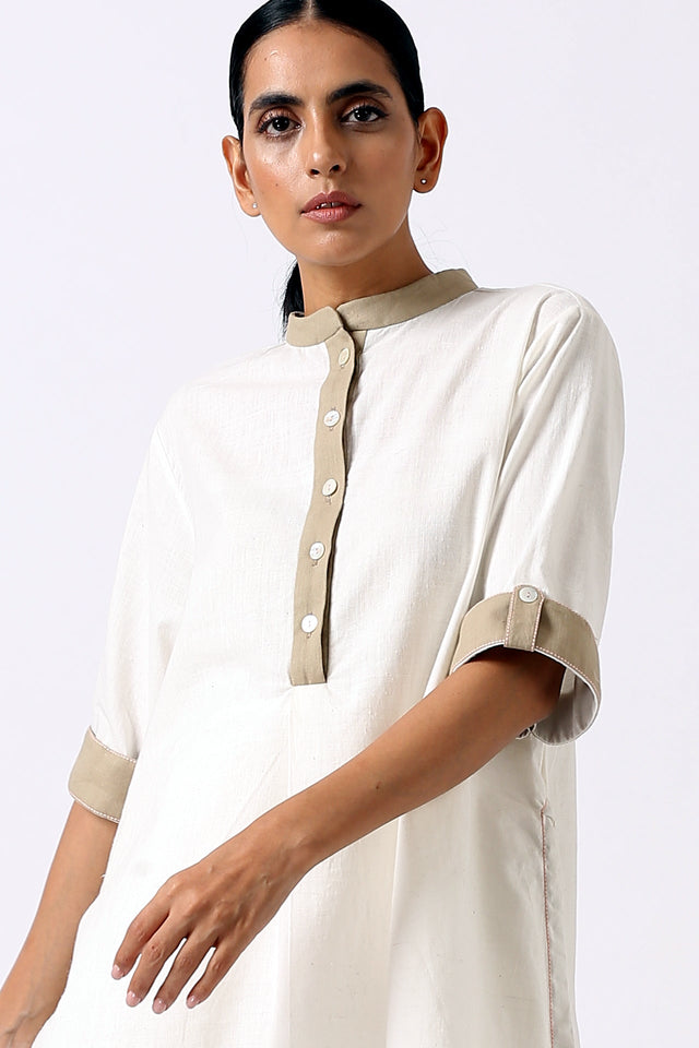 Close view of the Ivory Sabah tunic mandarin collar, button placket and short sleeve cuff