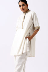Ivory Sabah mandarin tunic set with a hand in the pocket, close three quarter view