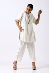 Ivory Sabah tunic with rolled beige cuffs and piped pants, full length front view
