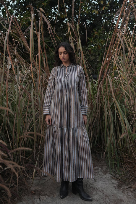 Model wearing the Akari Striped Dress in Brown by MAGO, long tiered shirt dress with collar, front view
