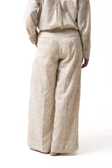 Beige paisley Rooh Pants with wide legs and pleats, lower back view