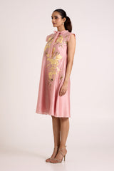 Ice pink Helga day dress with tab sleeves and floral applique, three quarter side view