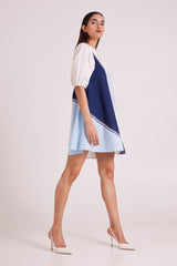 Juno segmented tide dress with puff sleeves stepping forward, three quarter side view