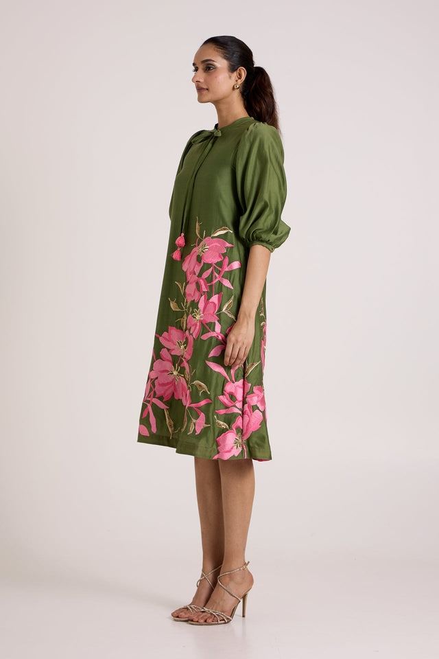 Olive Vinny day dress with pink floral applique at the hem, three quarter view