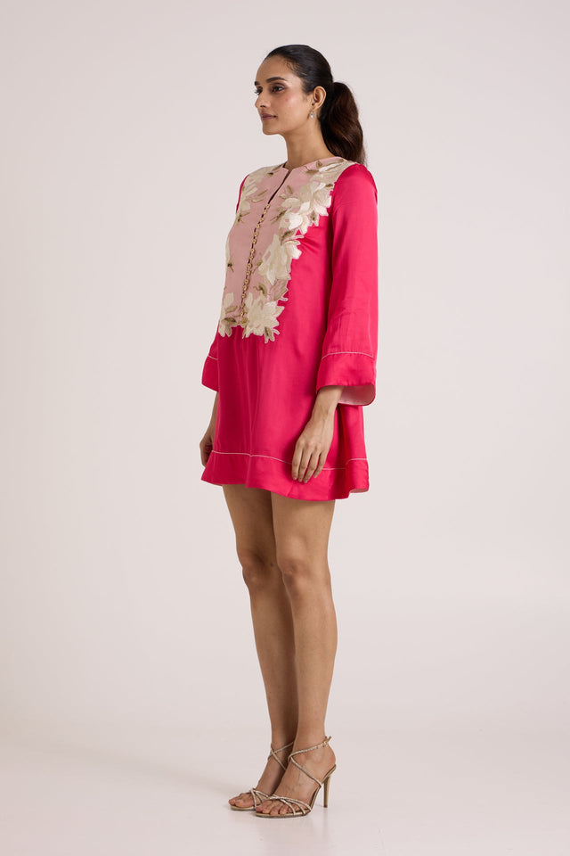 Jay pink Cory panelled short dress, side view showing the bell sleeve and applique bib