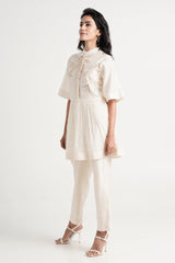 Ivory Abe 2.5 peplum tunic set with band collar and tonal floral embroidery, three quarter view