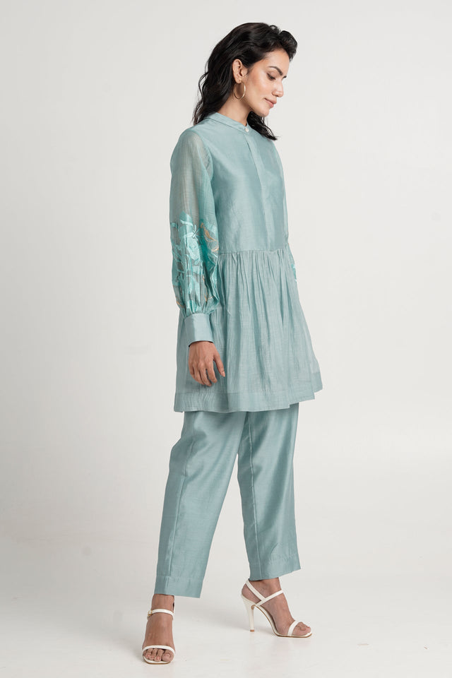Aqua Abe 2.0 tunic set looking down, side view of the gathered peplum and balloon sleeve