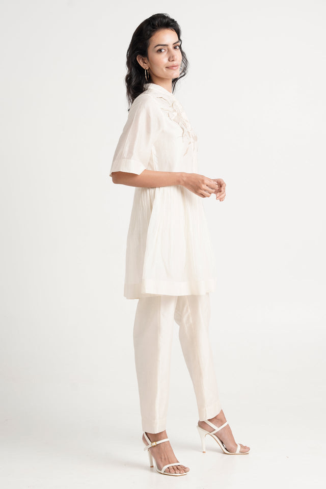Ivory Abe 2.5 tunic and slim pants with strappy heels, full length side view