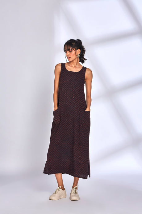 Aura Black Dress with hands in both front pockets, front view