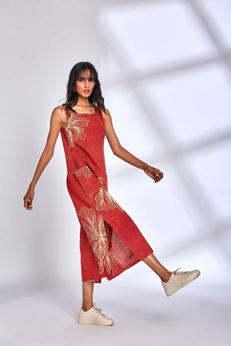 Model in motion in the Aura Red Dress showing the side slit and floral print
