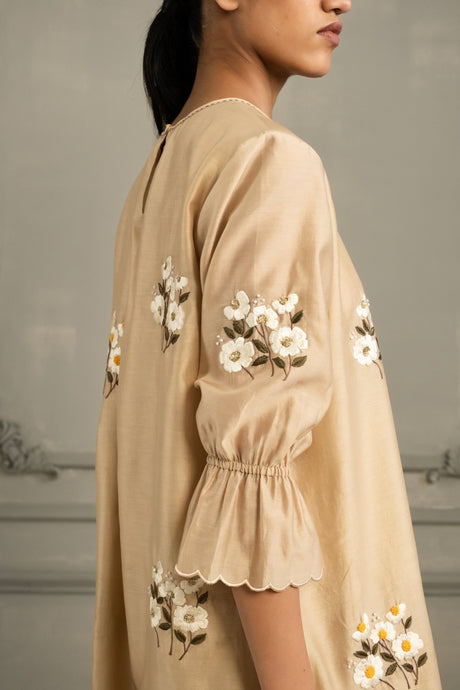 Close-up of the beige Chanderi Tunic sleeve with scalloped cuff and white daisy embroidery