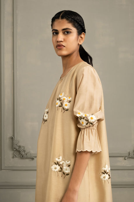 Model wearing the beige Chanderi Tunic with ruffled scalloped sleeve cuffs, three quarter view