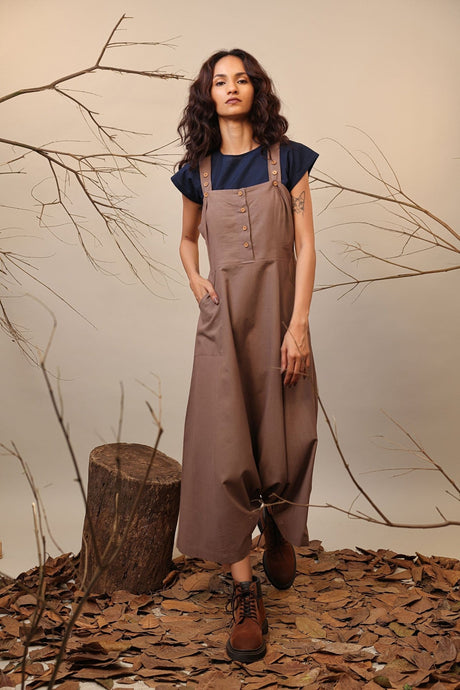 Model wearing the Beige Dungarees with hand in pocket, three quarter front view