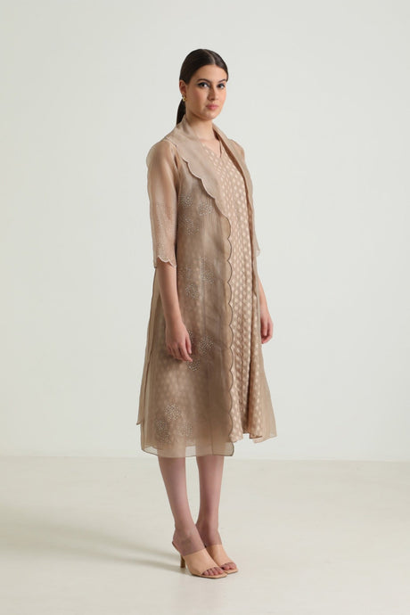 Model wearing the beige Printed Organza Jacket with scalloped collar over the Brocade Dress, side view