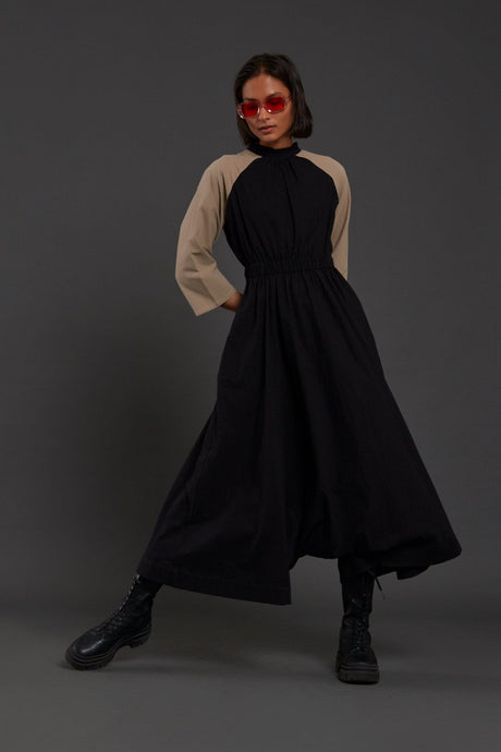 Black & Beige Sphara Jumpsuit mid stride, showing the dropped crotch volume