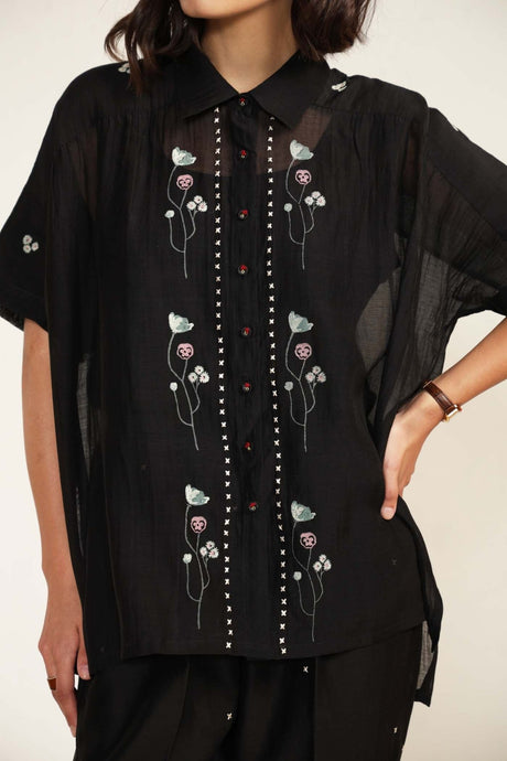 Close-up of the black Mul Chanderi Shirt collar, white stitch placket and pink floral embroidery