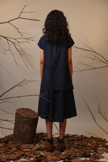 Back view of the navy Blue CB Stara Dress showing the layered top and skirt shape