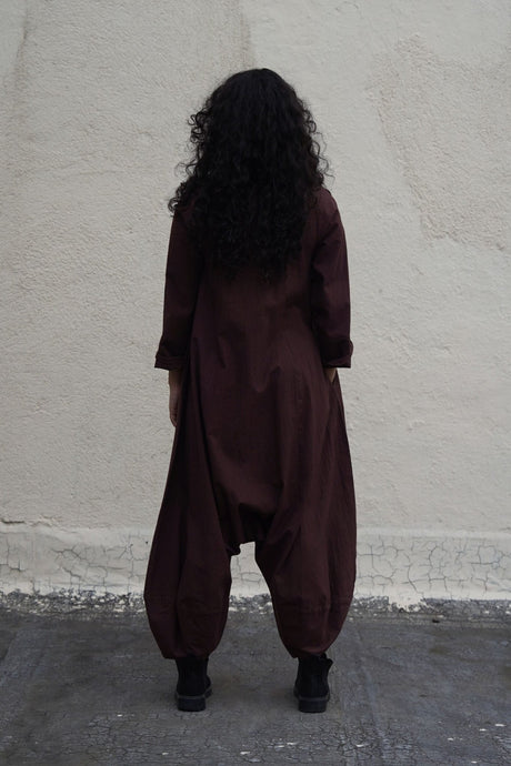 Back view of the brown collar sleeve Suga jumpsuit with dropped crotch