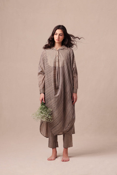 Model wearing the Charcoal Striped Shirt Cowl Tunic & SE Pants set holding flowers, full length front view