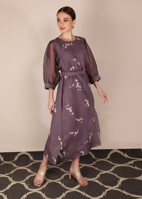 Model wearing the Cherry Blossom Lavender Dress with belted waist and sheer puff sleeves, side view