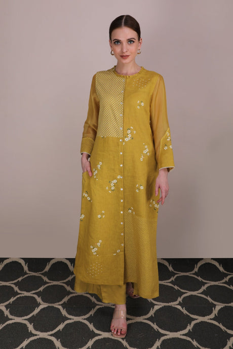 Model wearing the ochre Cherry Blossom Multi Print Pants with button front tunic, full length view