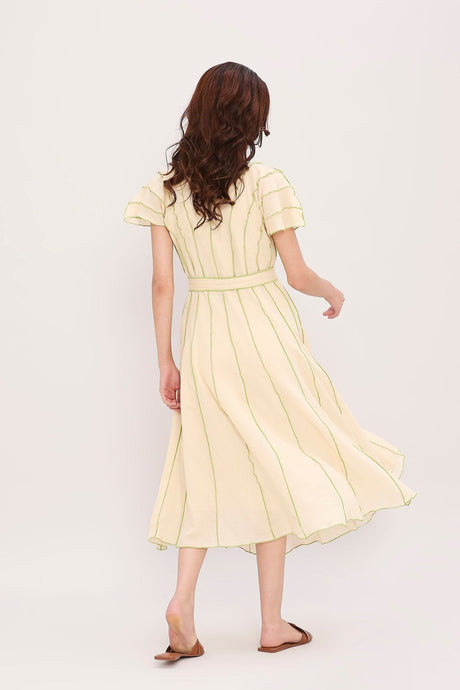 Back view of the belted Coco cream moss panelled dress in motion