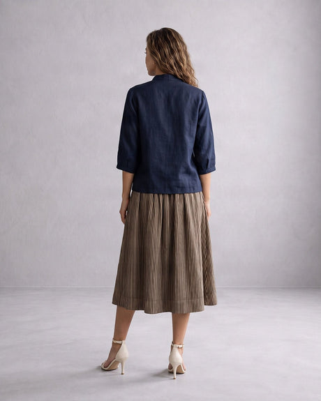 Model wearing the navy Collar Cotton Crop Top with pleated skirt, back view of the dropped shoulders