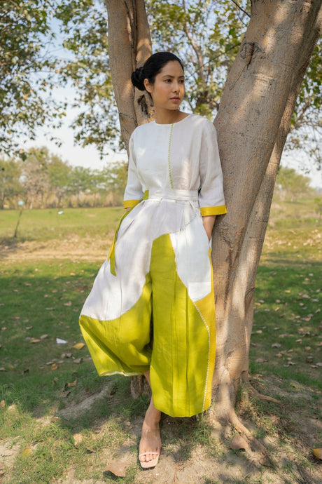 Color block Linen Jumpsuit by ARCVSH by Pallavi Singh in white and chartreuse with yellow tie belt, front view outdoors