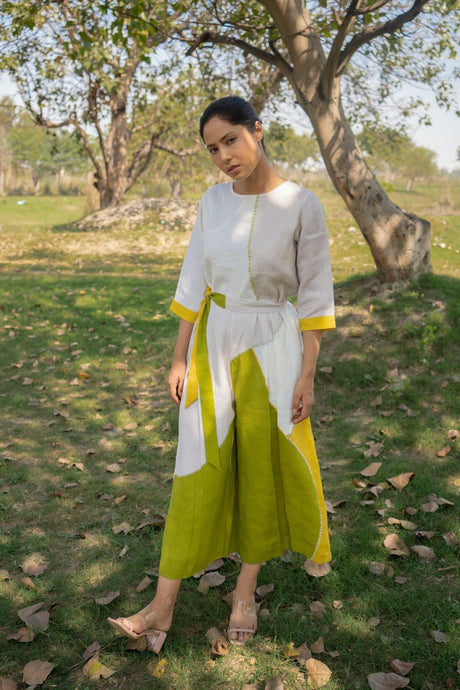 Model walking in the Color block Linen Jumpsuit with wide chartreuse legs, full length view