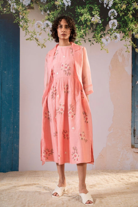 Model wearing the pink Dahlia Print Gathered Dress with sheer organza jacket, three quarter front view