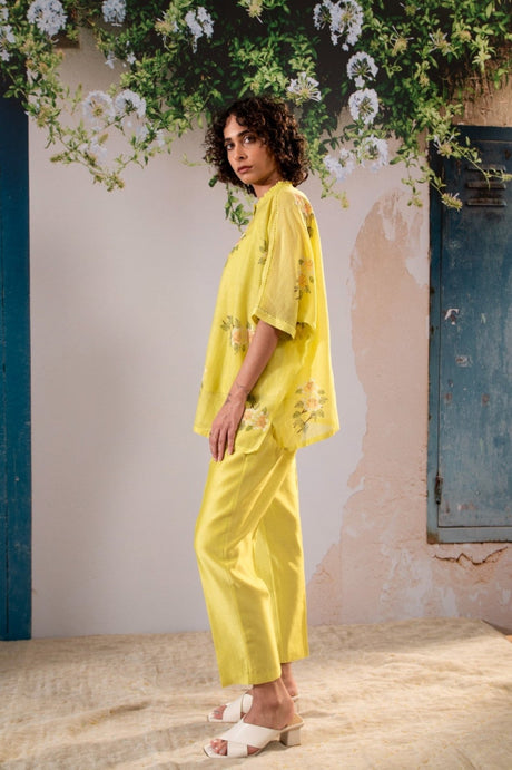 Model wearing the yellow Dahlia Print Kaftan Top with straight pants, side view