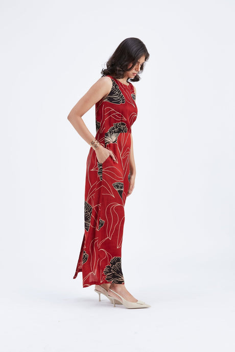 Model looking down in the Elara Dress with hand in pocket, side view
