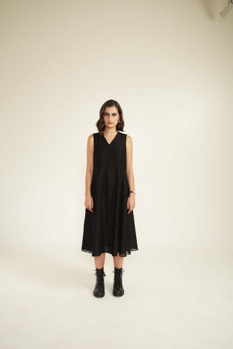 Model wearing the black plain brocade dress without the jacket, front view