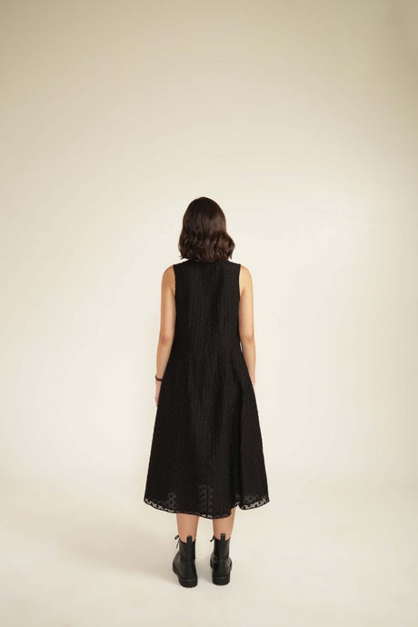 Black plain brocade dress back view without the jacket, model wearing it