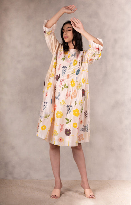 Floral print pink Chanderi tuck dress front view with arms raised showing the sleeves