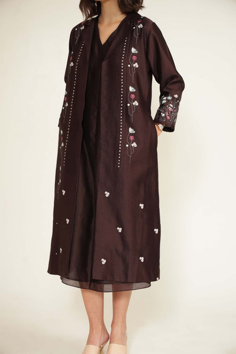 Close-up of the grape jacket lapel, embroidered sleeve and V-neck dress