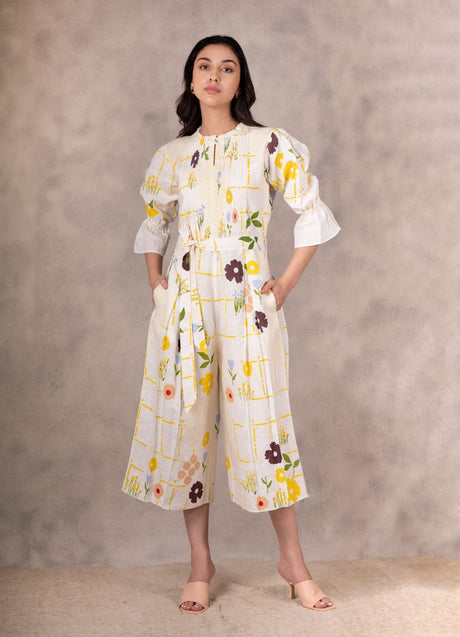 Model wearing the ivory floral jumpsuit with tie belt and cropped wide legs, front view
