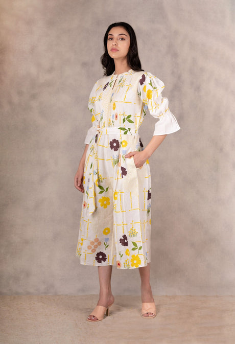 Model with hands in pockets wearing the hand block floral jumpsuit, front view