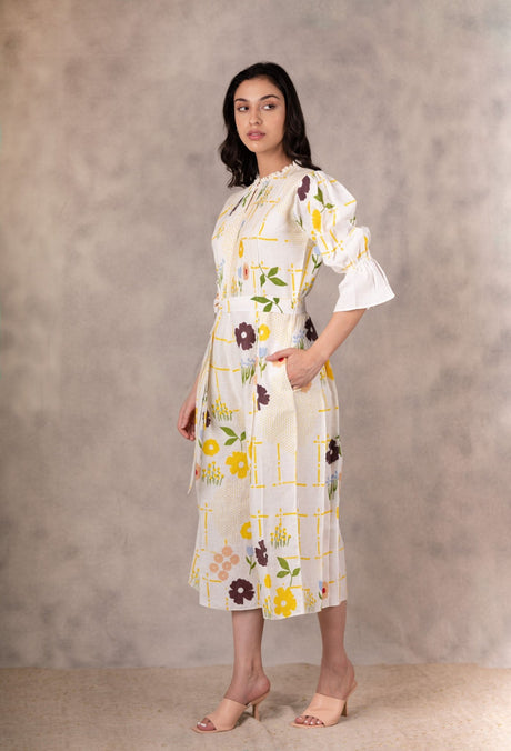 Model wearing the ivory floral linen jumpsuit, three-quarter side view