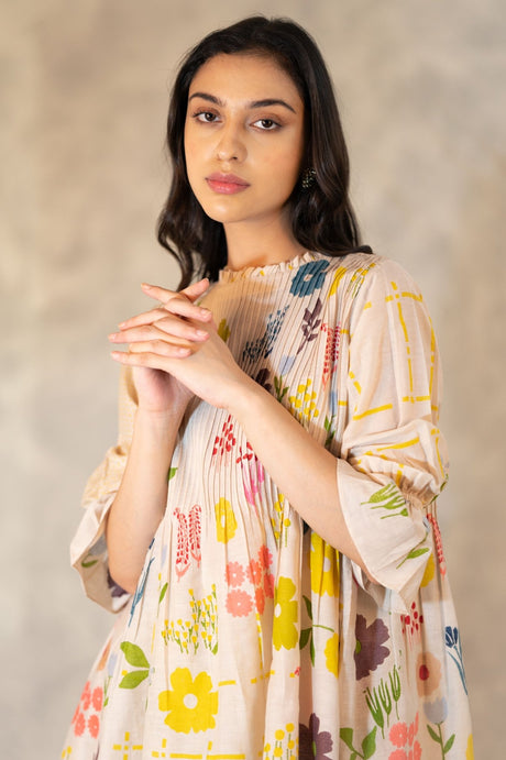 Close-up of the pink tuck top showing pintucks and multicolour hand block flowers