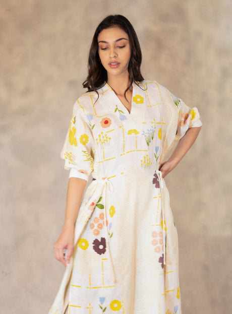 Handmade floral linen dress close front view with hand on hip and V collar