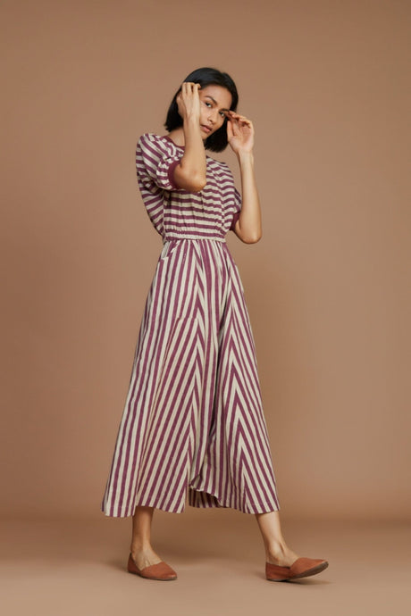 Model wearing the Ivory and Mauve Striped Mati Sphara Jumpsuit, three quarter view showing the wide legs
